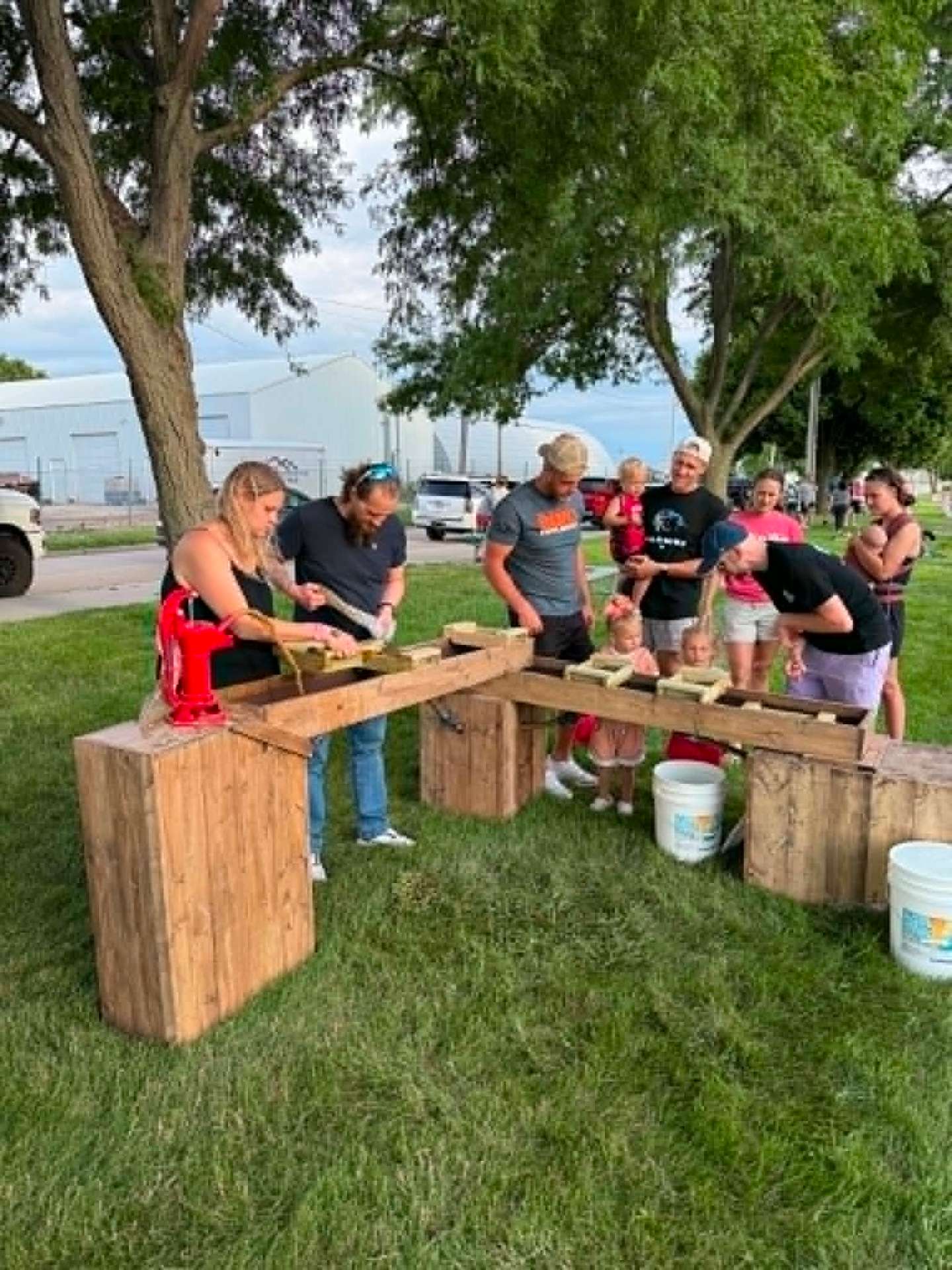 Adults working the sluice together